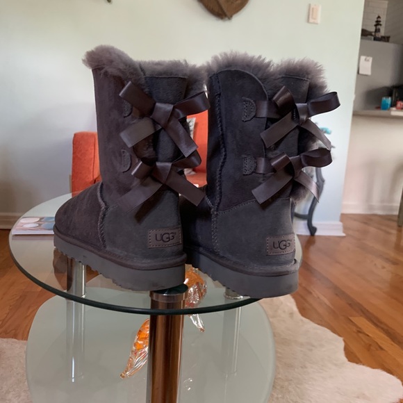 UGG Bailey Bow Boots that are a light grey color. - Picture 2 of 6